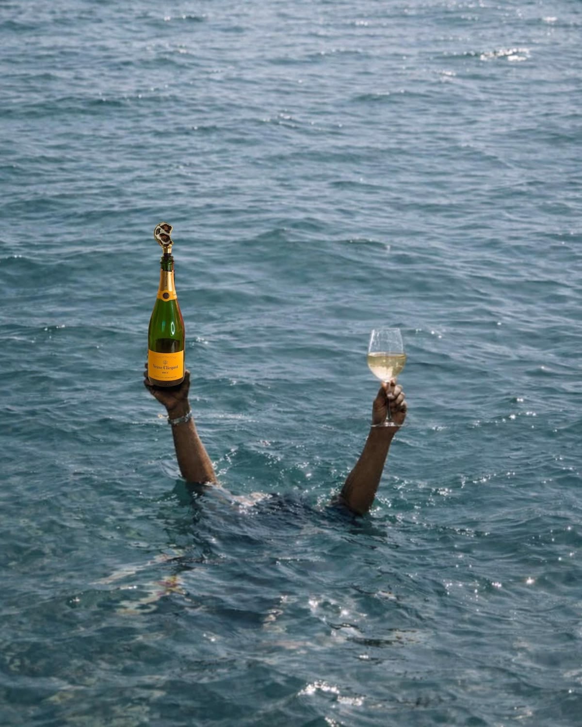 Champagne and wine raised above the sea